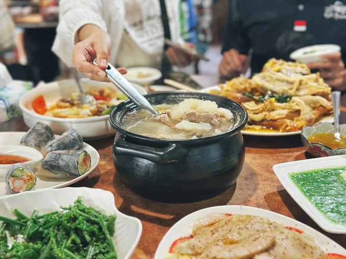 G九屋私房特色菜餐桌擺滿金針花湯與多道在地特色料理
