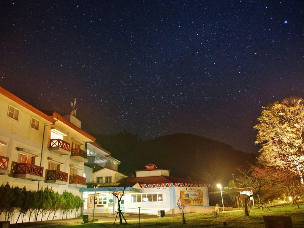 夜幕低垂，阿里山青年活動中心的燈光亮起，與天上的星空相互輝映，寧靜而美好。
