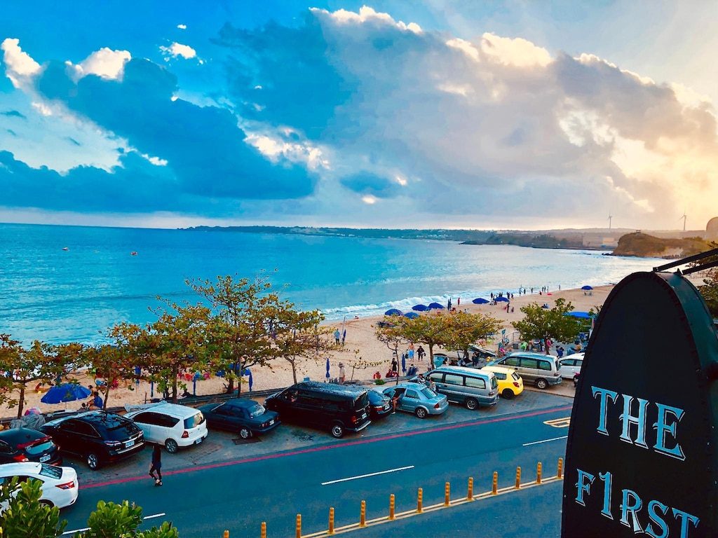 南灣海灘熱鬧非凡，遊客享受陽傘下的悠閒時光與刺激的水上活動。