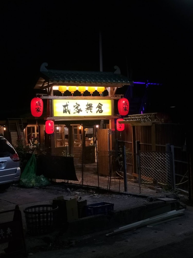 日式風格餐館門口掛著紅燈籠與大招牌，夜晚燈光明亮