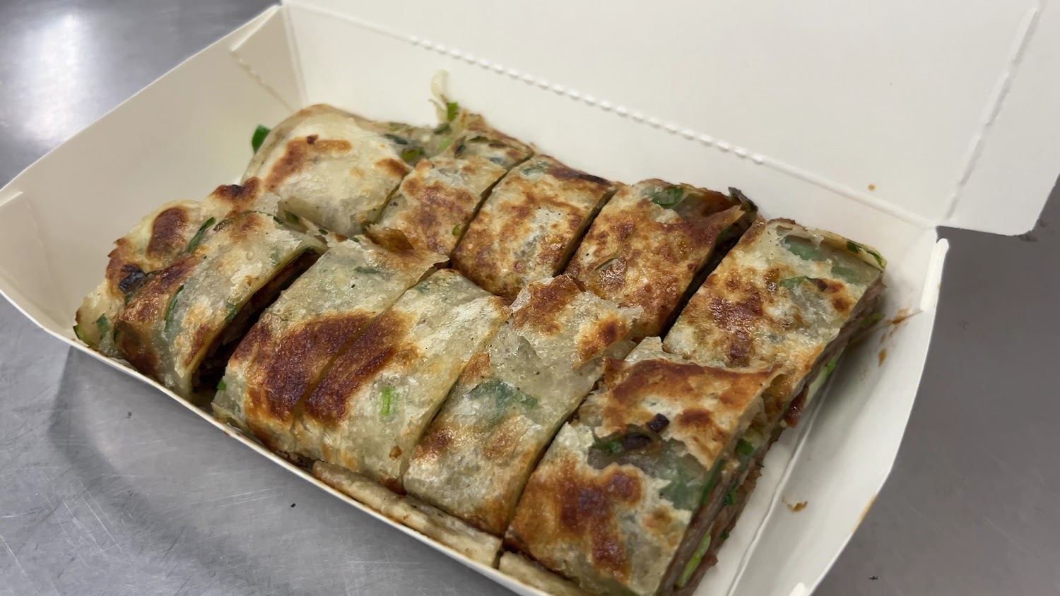 切片牛肉捲餅外皮酥香內夾牛肉與蔥段
