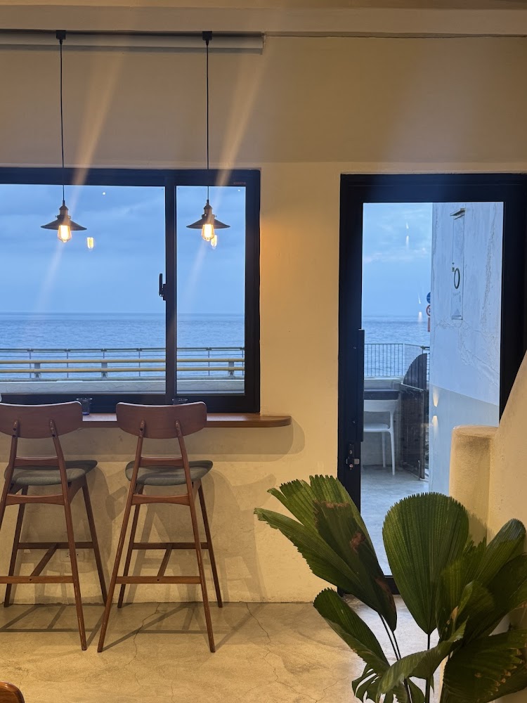 靠海咖啡館內部高腳椅窗景與吊燈