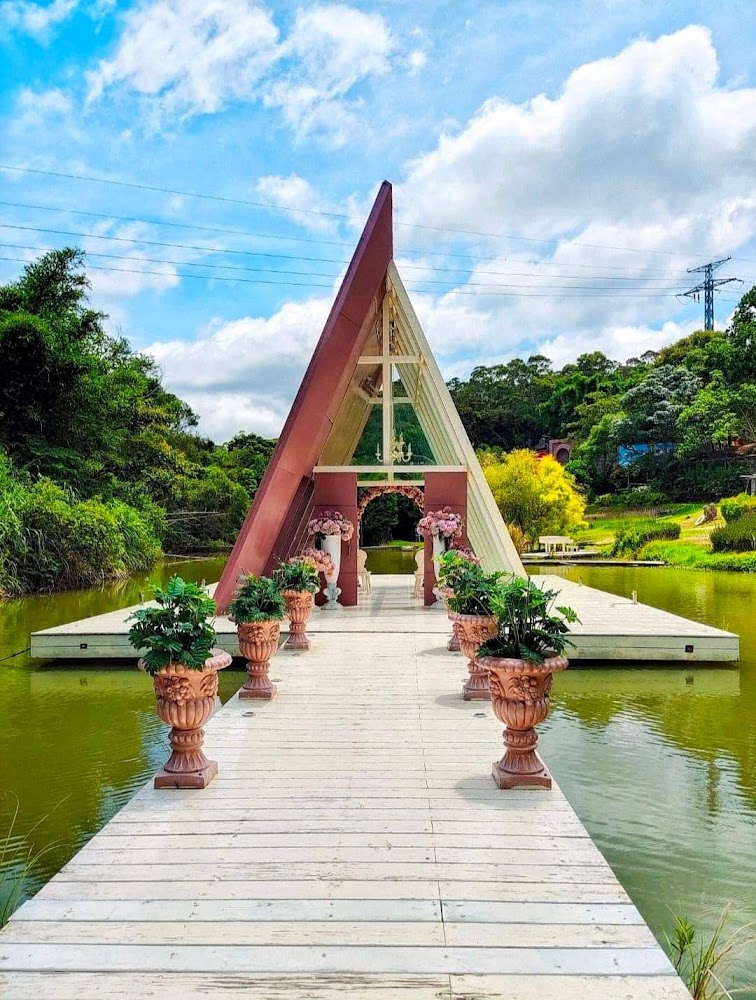 湖中央的三角形A字型建築,前方有白色木棧道通往建築。