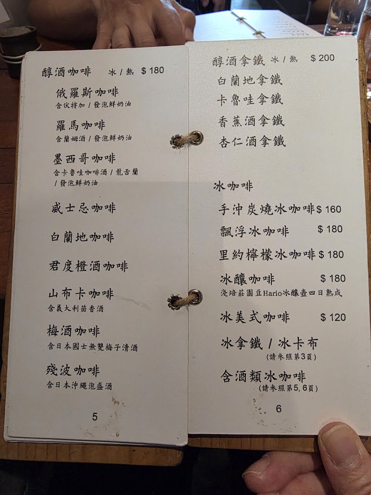 這是一張咖啡廳酒精咖啡和冷飲咖啡的菜單，左頁主推各國特色酒精咖啡，右頁有酒精拿鐵及各式冰咖啡，並標示價格。