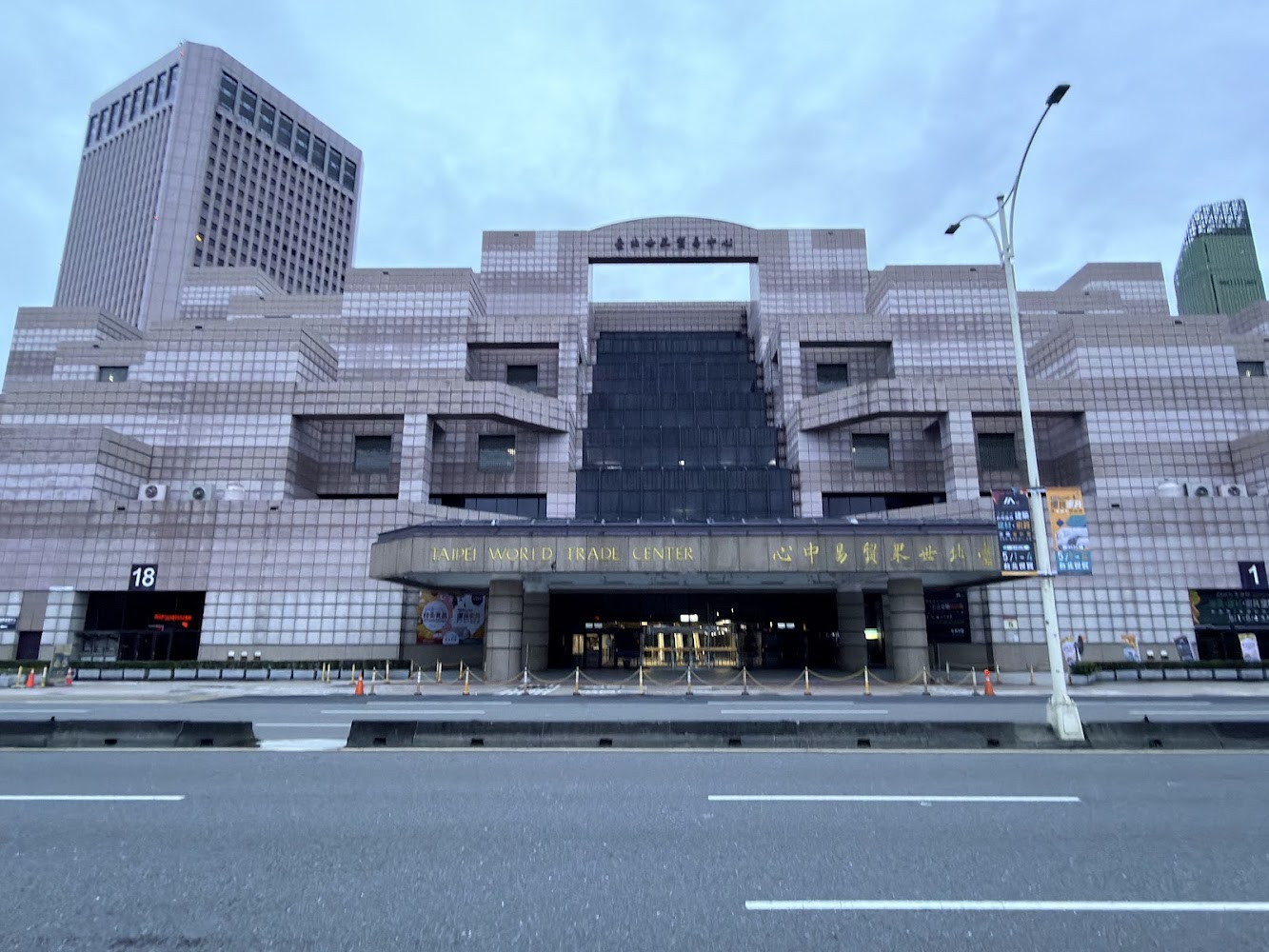 台北世界貿易中心展覽大樓正門外觀，入口標示清楚，建築外牆為淡色方格設計。