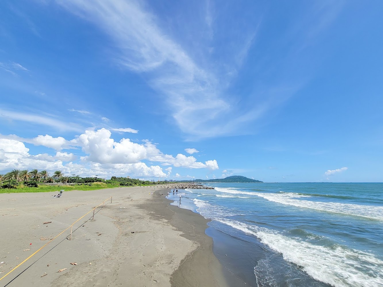 藍海白雲與海浪拍岸的寧靜景色
