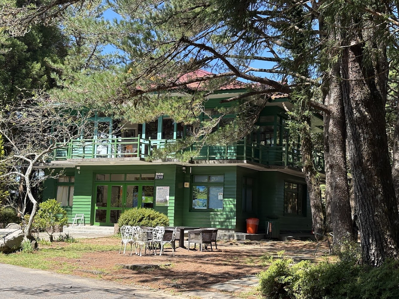 天池旁綠色木造建築被高大樹林包圍