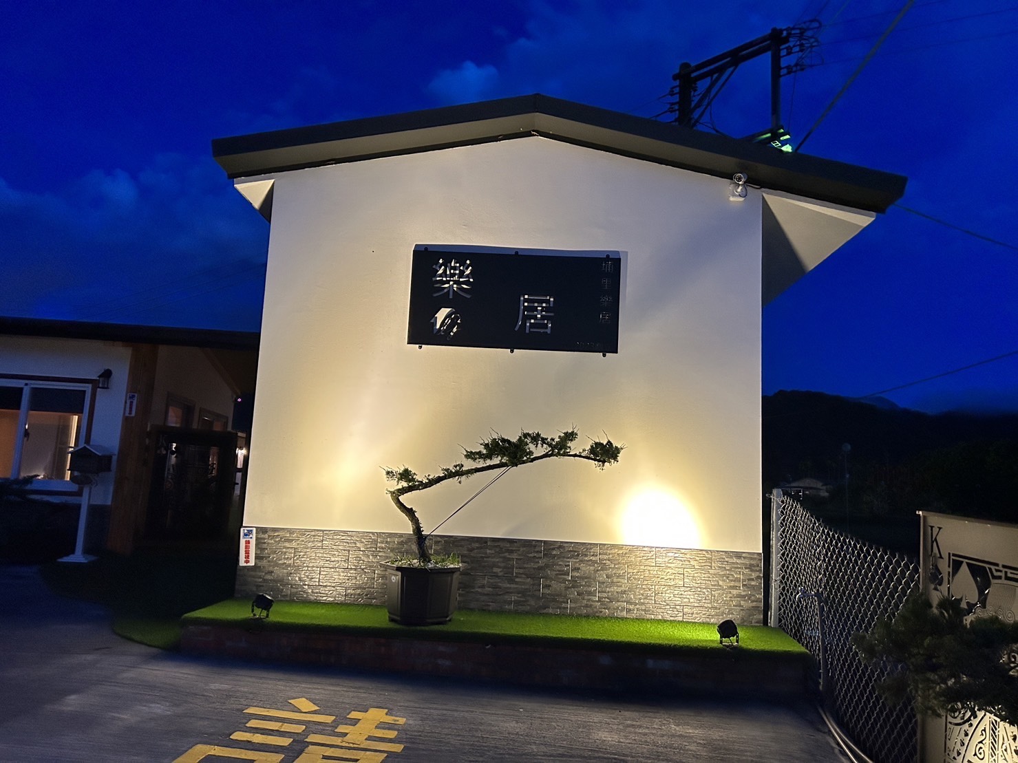 夜間樂居招牌與白色建築