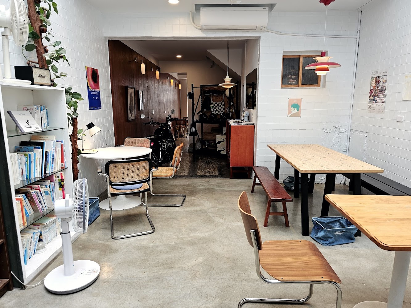 薄荷巴黎 Coffee House 閱讀空間有書架桌椅植栽與明亮採光