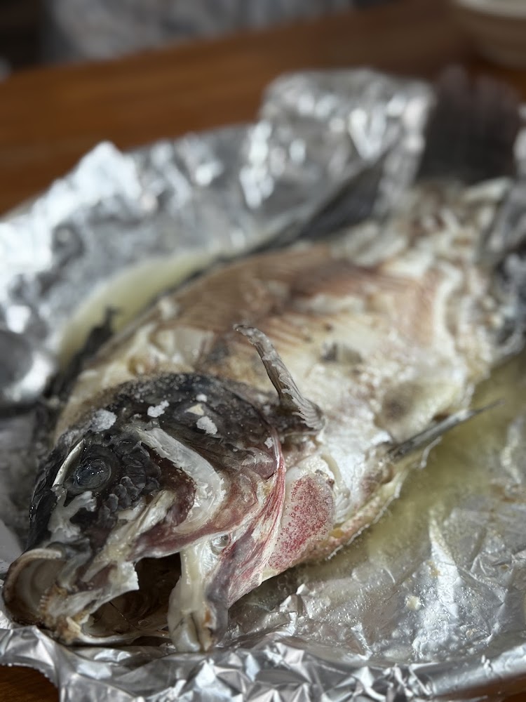 完整烤魚，魚身上撒有鹽巴，底下鋪有鋁箔紙