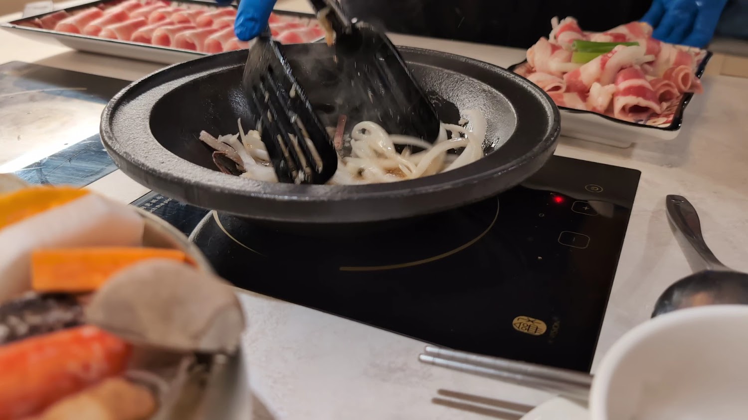 桌邊爆香石頭火鍋服務畫面與配料拌炒