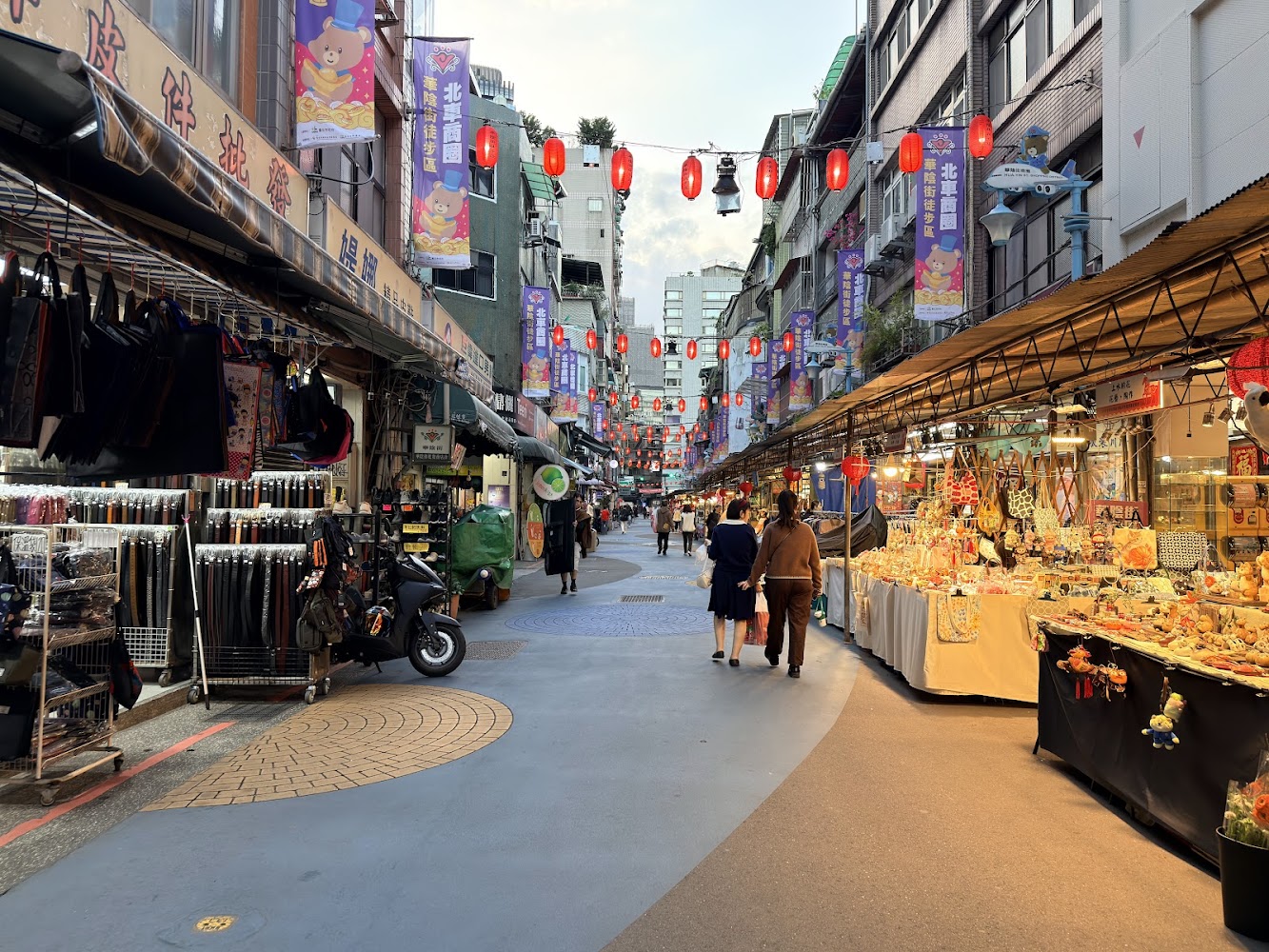 華陰街商圈熱鬧商店街，兩旁有包包與飾品店舖，街上掛著紅燈籠。