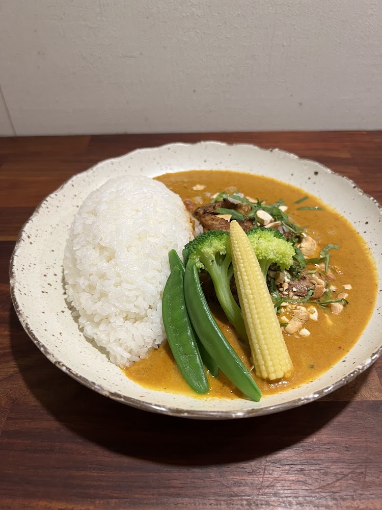 紅咖哩雞肉飯配白飯玉米筍青豆花椰菜與花生
