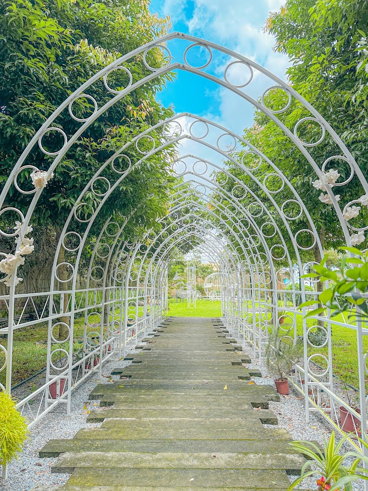 穿越花園的步道與白色鐵製拱門裝飾