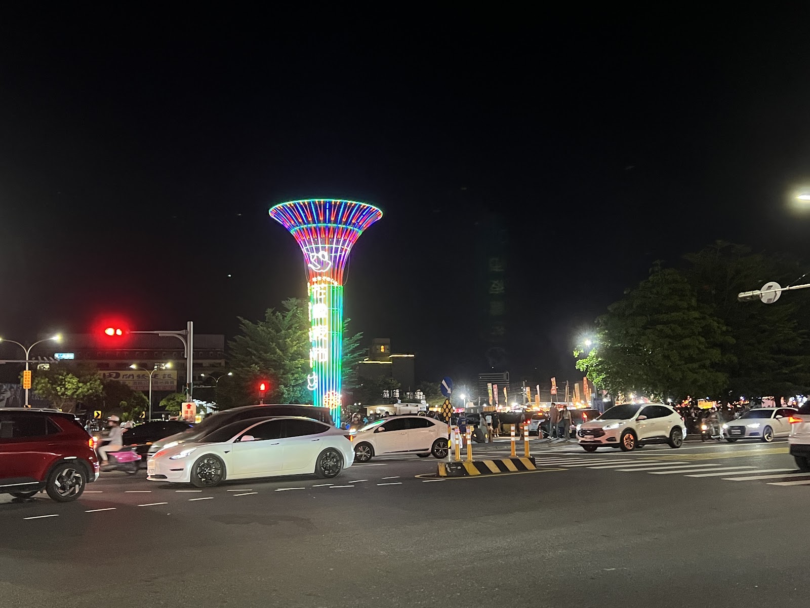 台南花園夜市入口廣場，彩色旋轉燈塔夜景，停車場寬廣