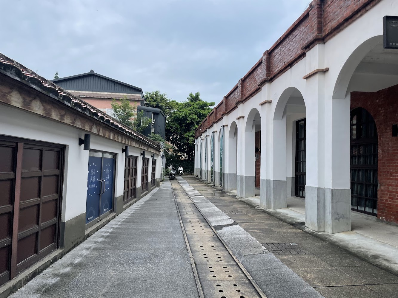 安靜巷弄與兩側歷史風格建築，中間有鐵軌延伸