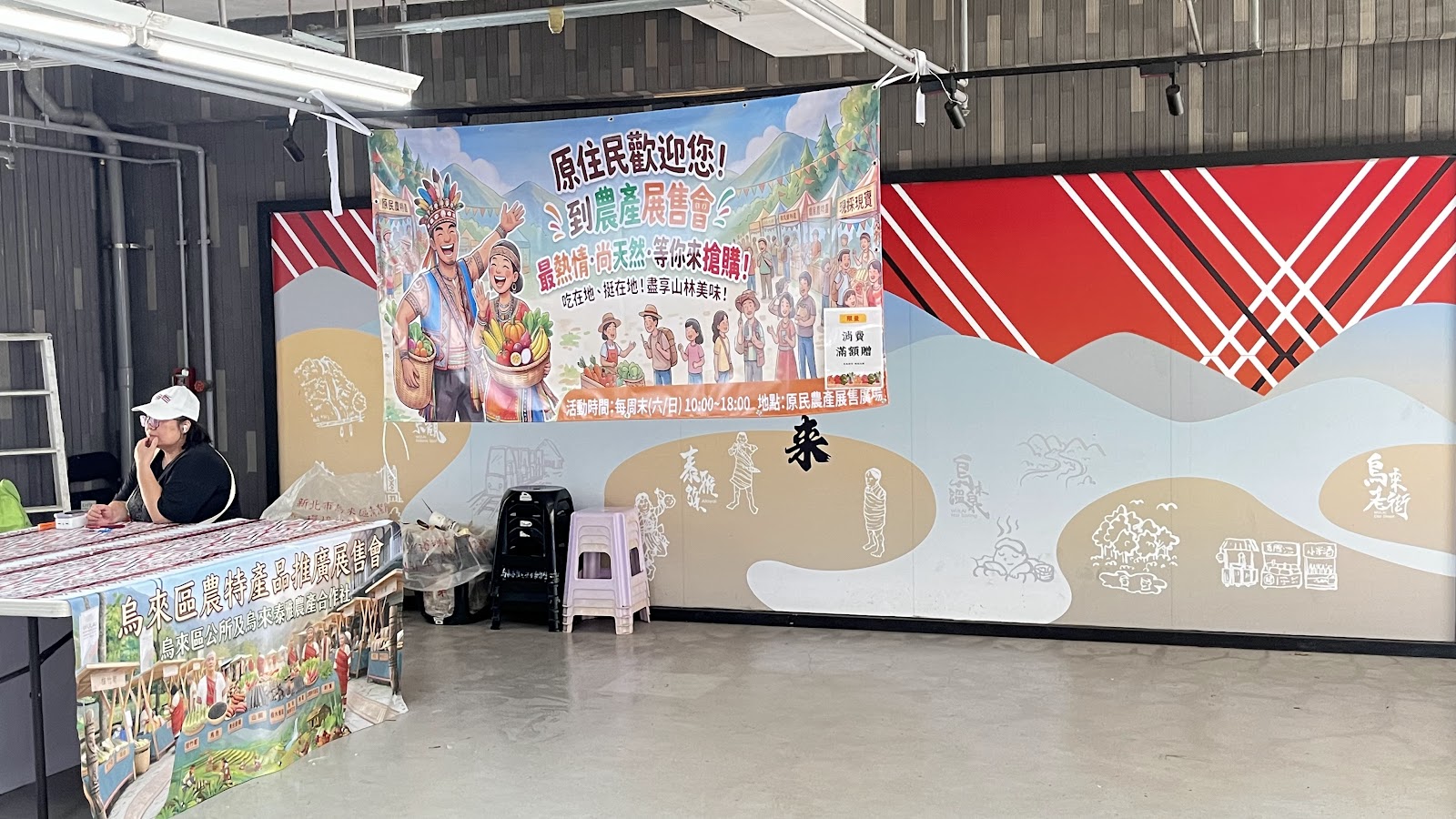 烏來老街原住民農特產品展售會，展場內有彩繪牆面與農產展台