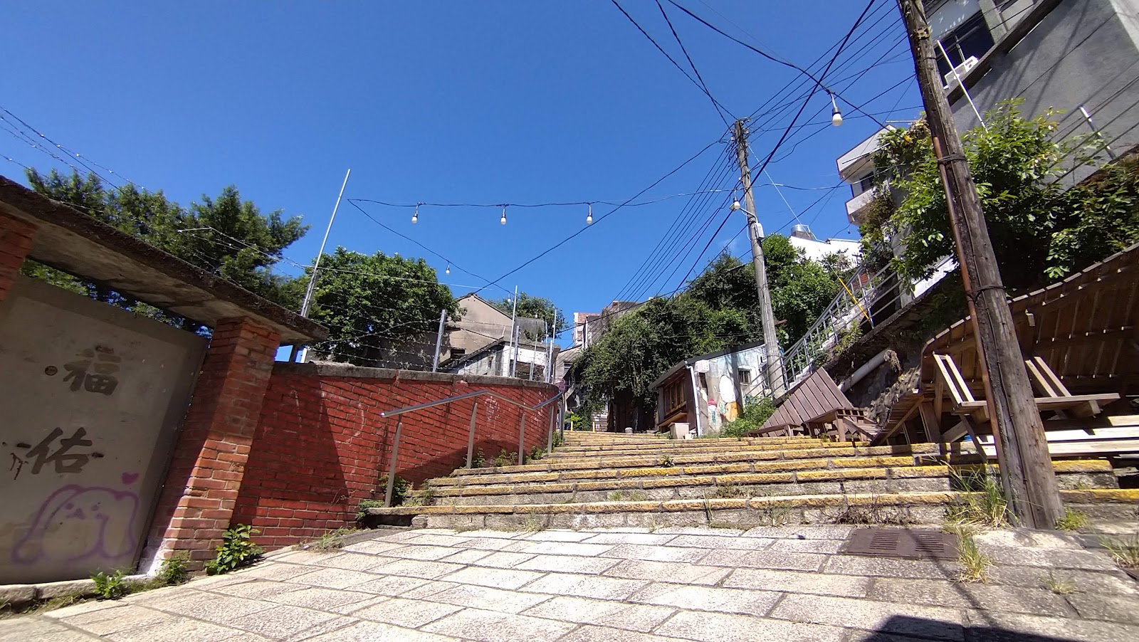 淡水重建街百年石板階梯仰拍視角，兩側串燈，古色古香懷舊感