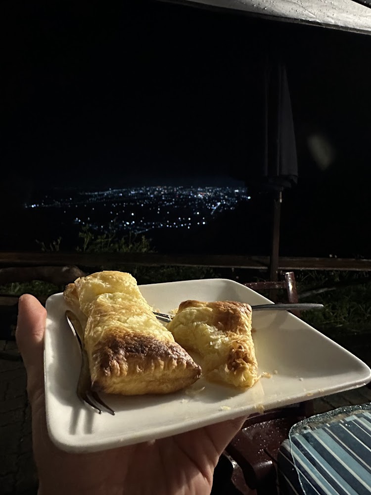 手拿酥皮點心與城市夜景
