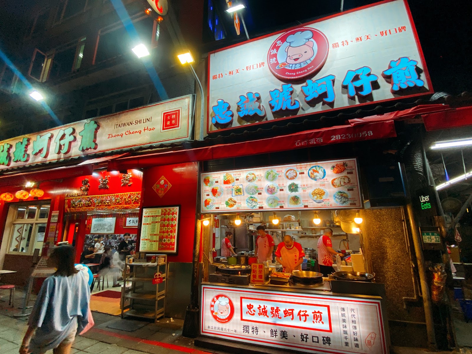 忠誠號蚵仔煎夜晚店面，廚師在開放式廚房製作蚵仔煎，店招寫著獨特鮮美好口碑