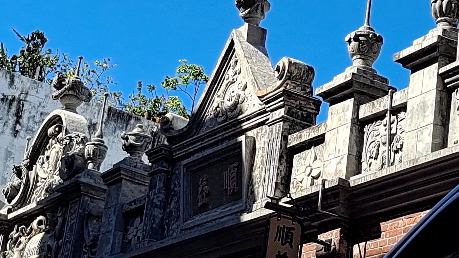 大溪老街閩南式建築山牆石雕細節，仿巴洛克風格精緻裝飾，藍天晴日