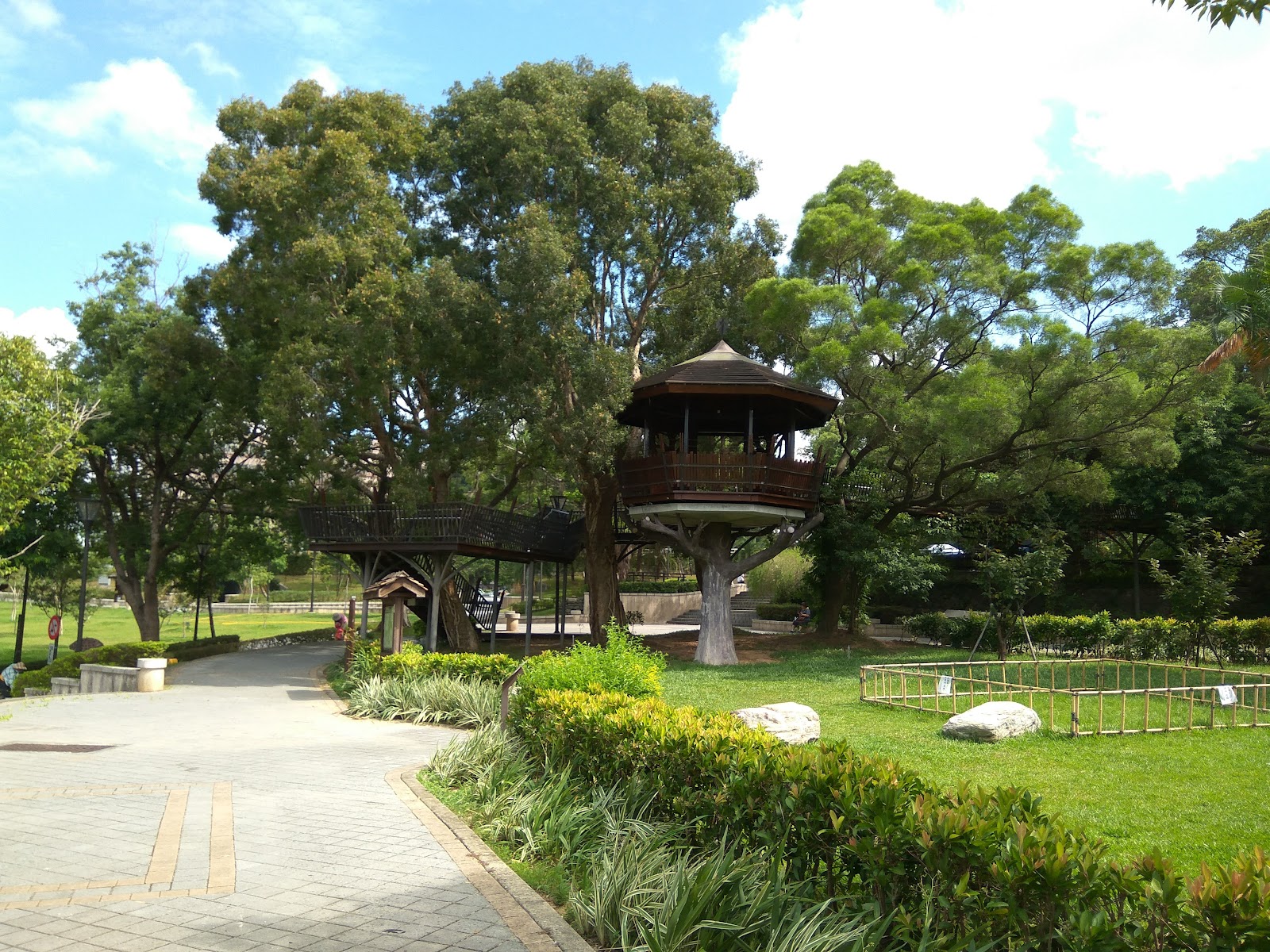 虎頭山公園廣場，木質圓形觀景台，綠草如茵，步道蜿蜒