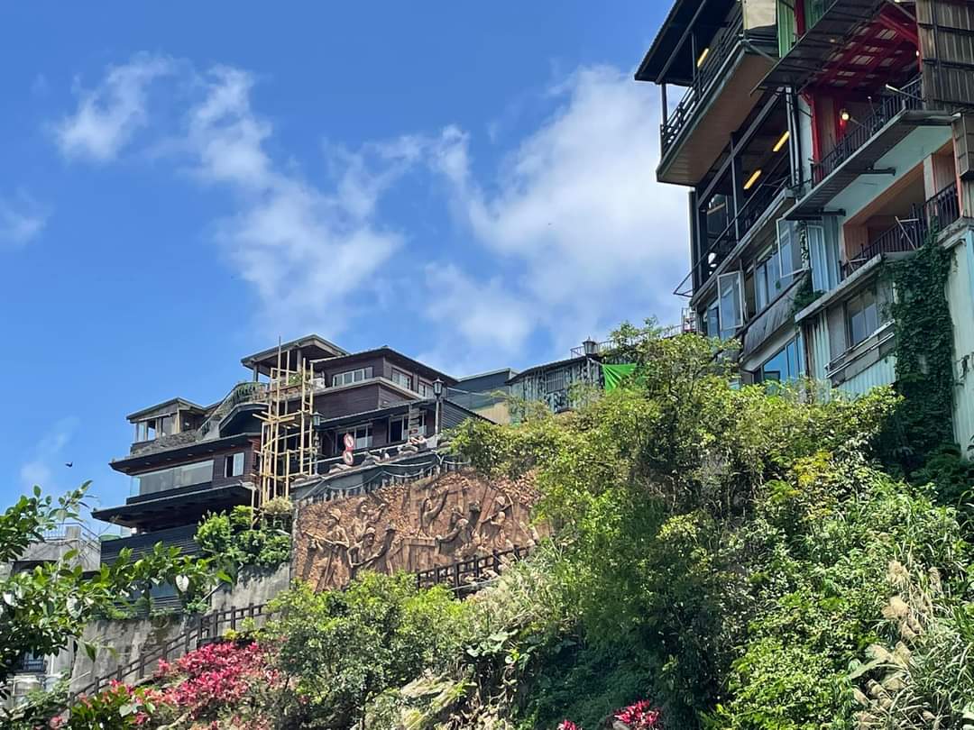 山坡建築與綠色植被及大型浮雕