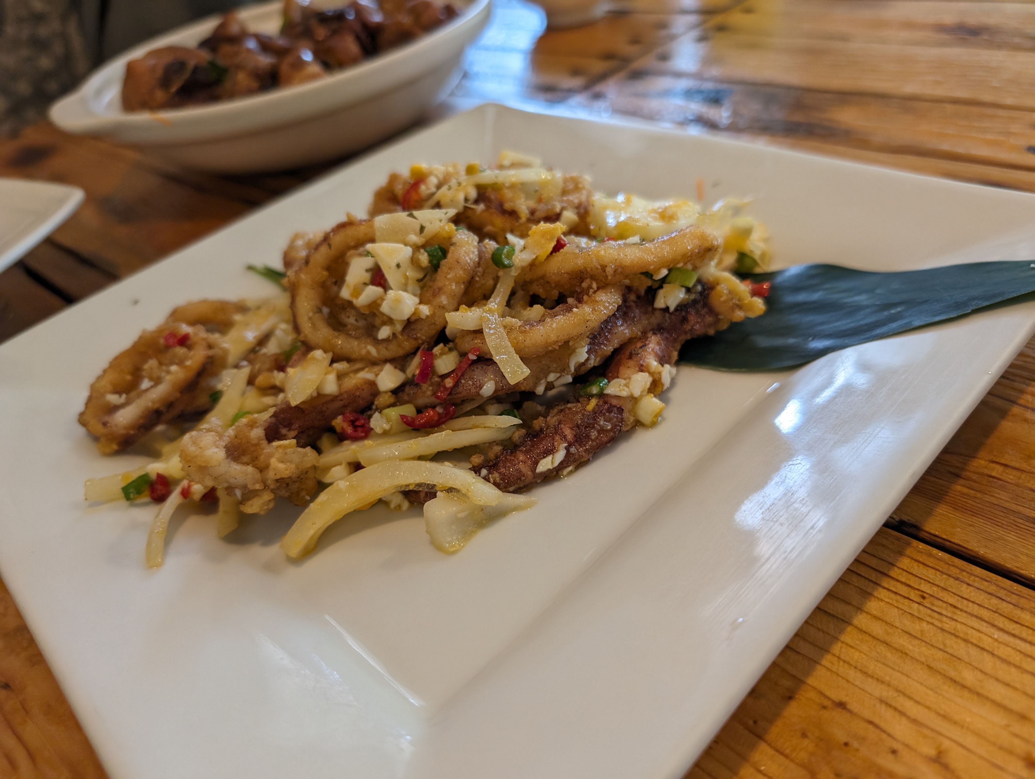 海人上菜酥炸花枝搭配蔥花蒜末與辣椒