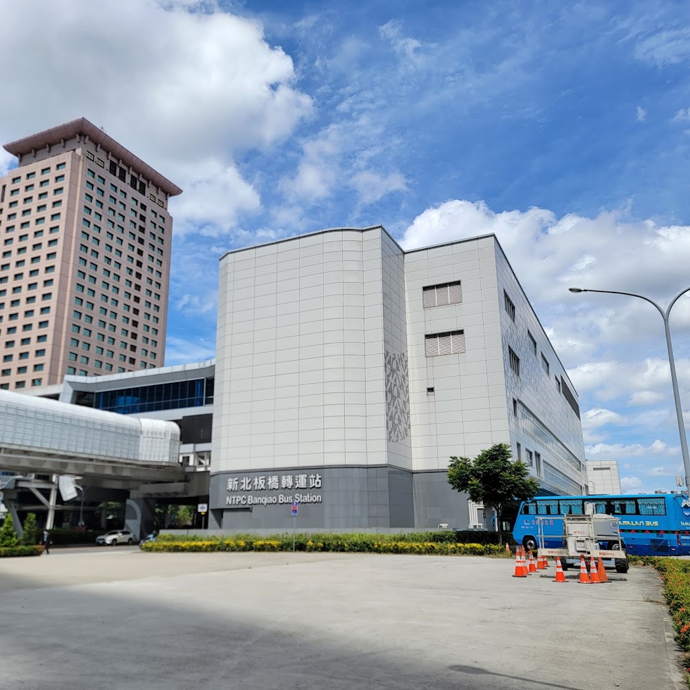 新北板橋轉運站外觀，旁邊停有藍色巴士，現場晴朗空曠