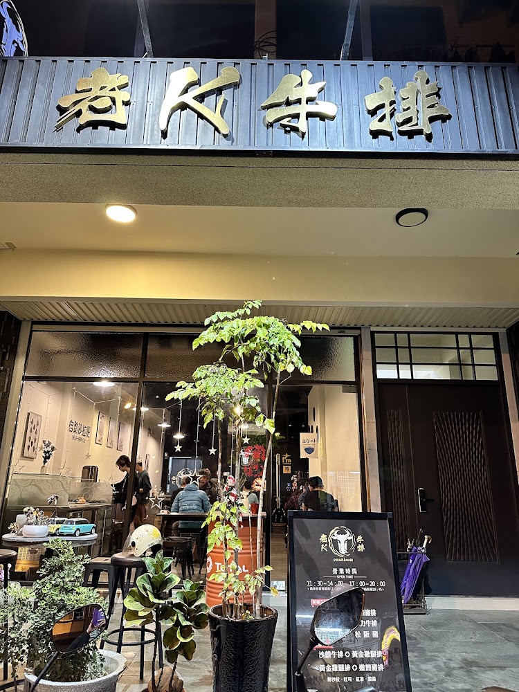 老K牛排自助沙拉吧店門口外觀，有綠色植栽與玻璃窗