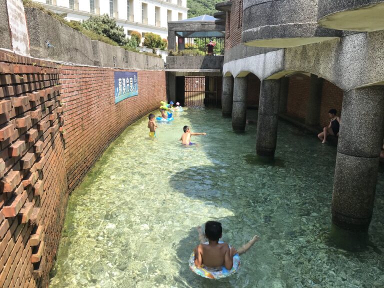 蘇澳冷泉公園戶外大眾冷泉池，孩童在碳酸冷泉中嬉戲，水面清澈透明