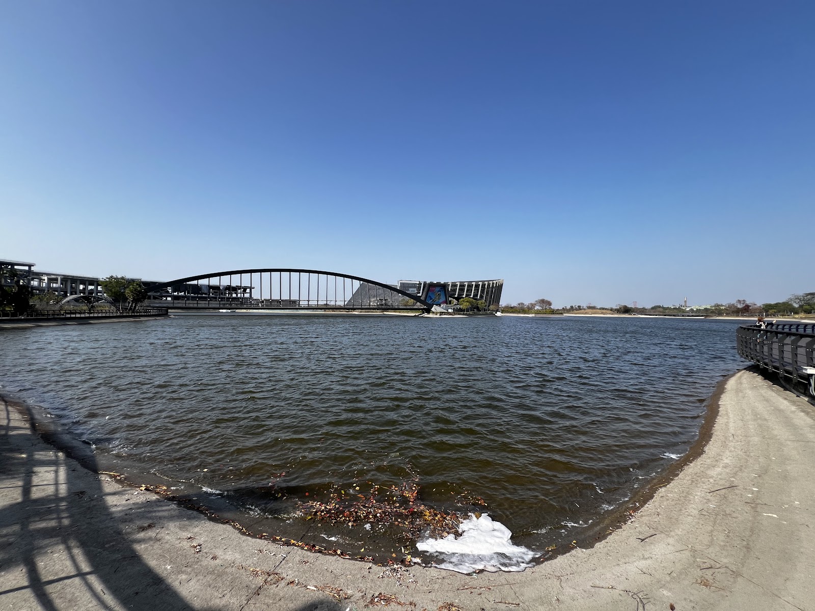 故宮南院湖岸遠眺，廣闊湖面，寬月橋拱橋和博物館建築群，晴天澄藍天空