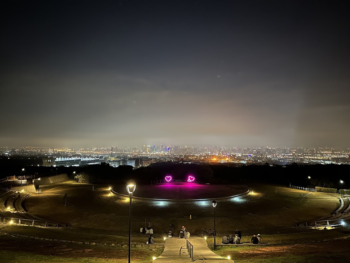 夜晚城市夜景與草地愛心裝置