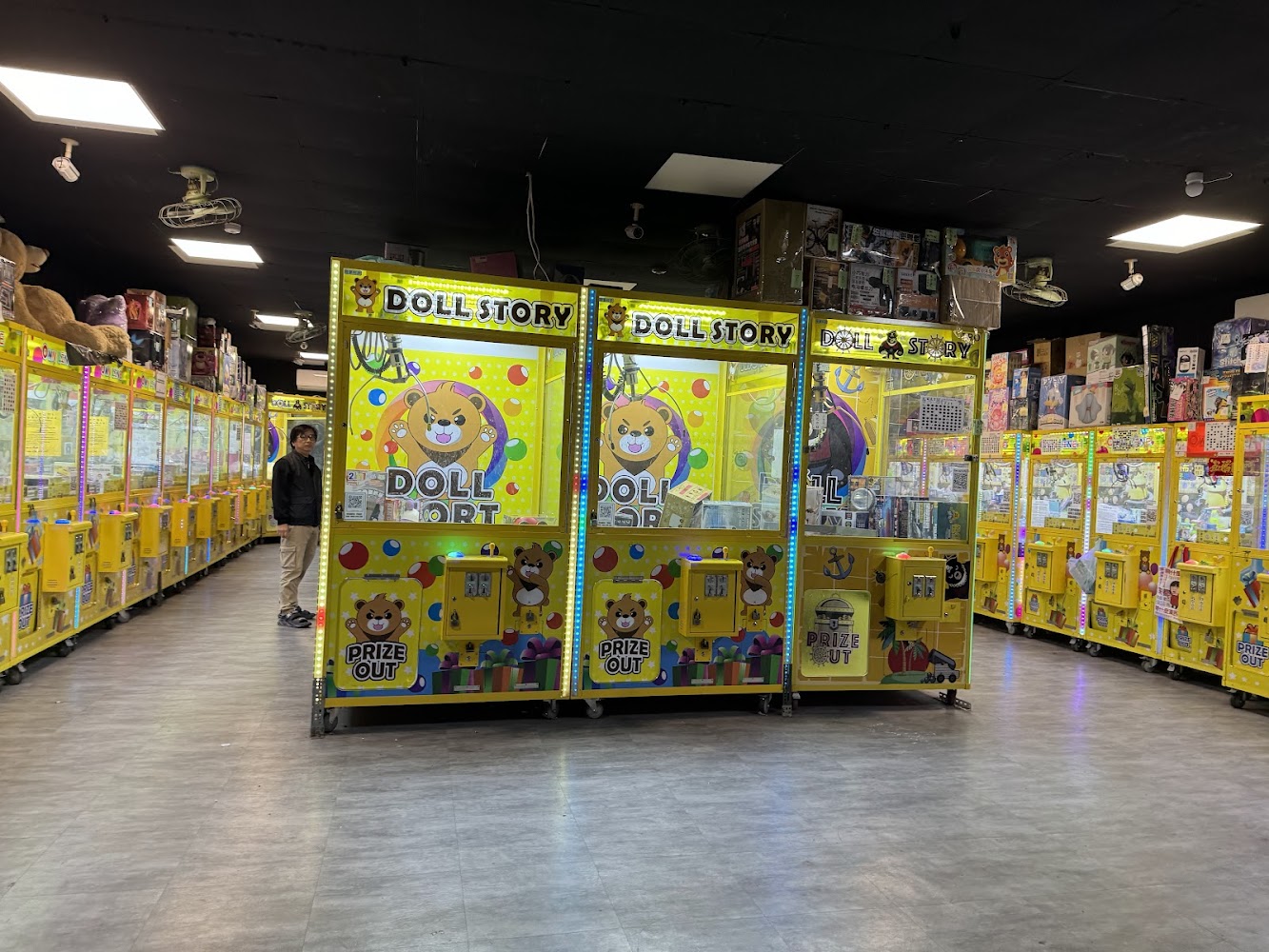店內黃色主題夾娃娃機與商品展示。