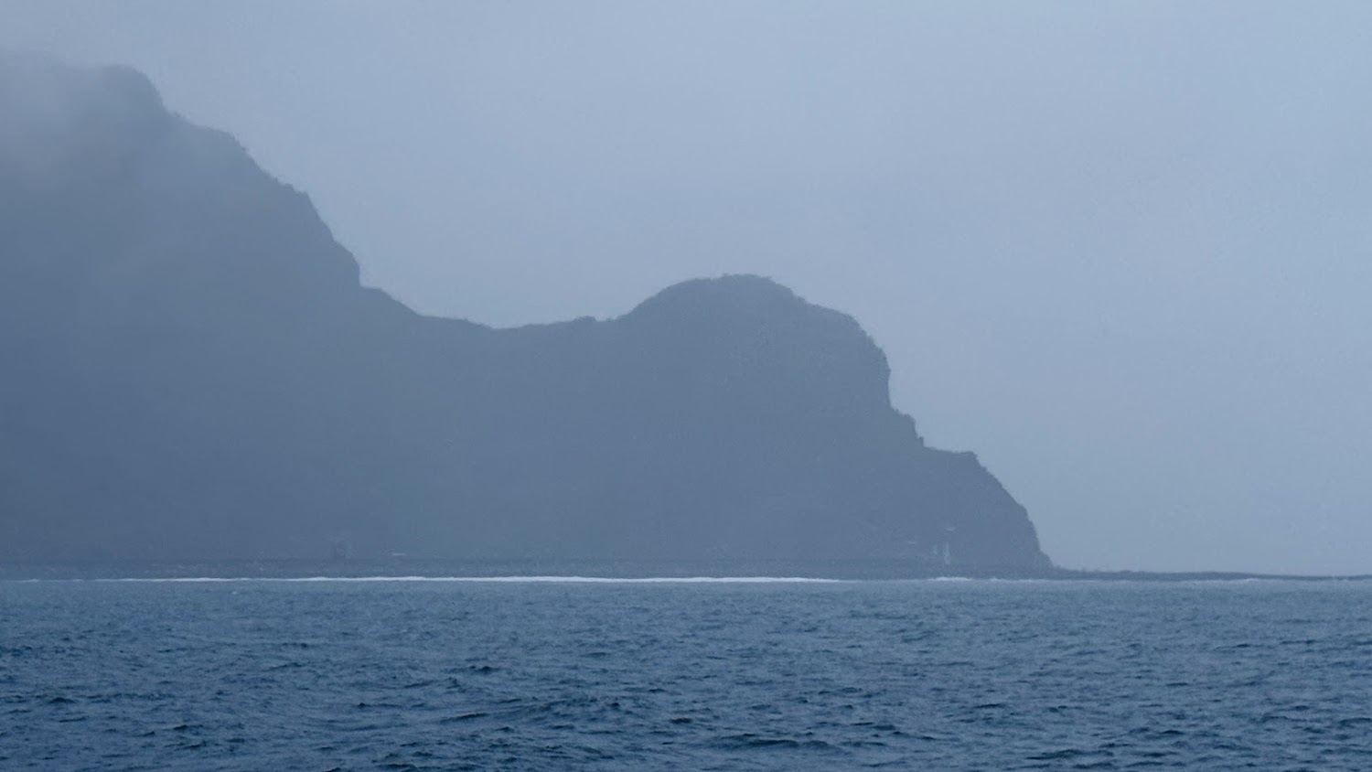 海面前景與雲霧籠罩山脈