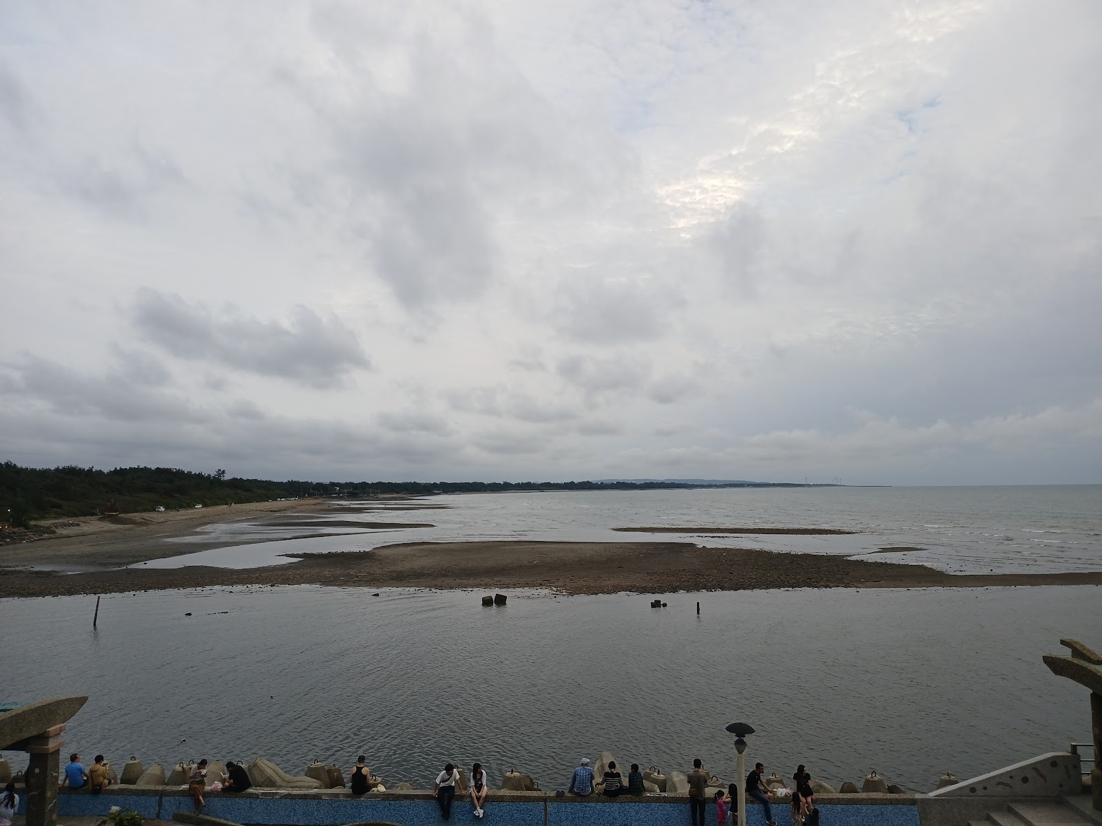 從永安漁港瞭望台俯瞰台灣海峽出海口，沙洲與海水交錯，視野遼闊，觀景台上遊客休憩