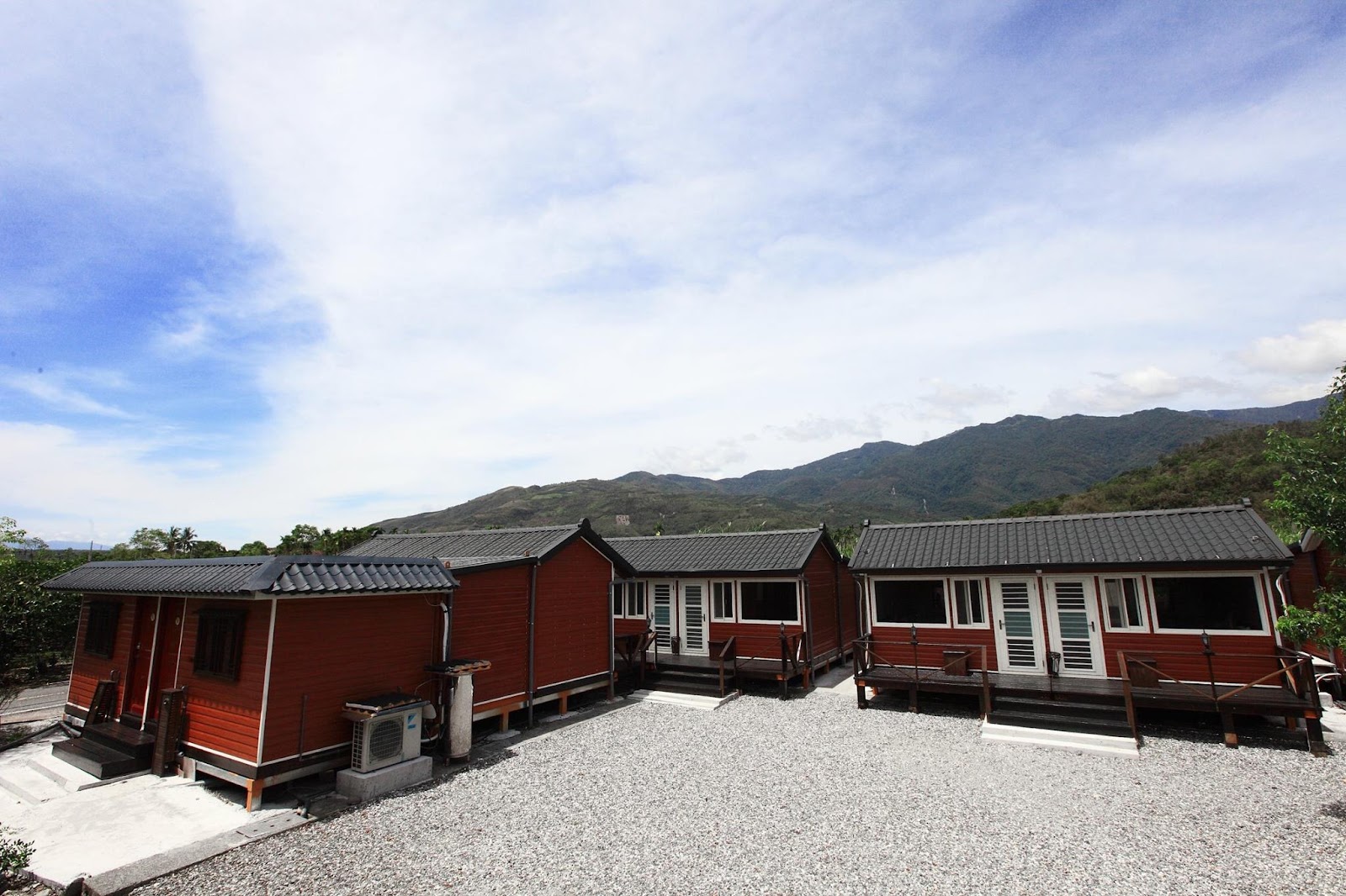 黃家溫泉木造客房群外觀，山景藍天