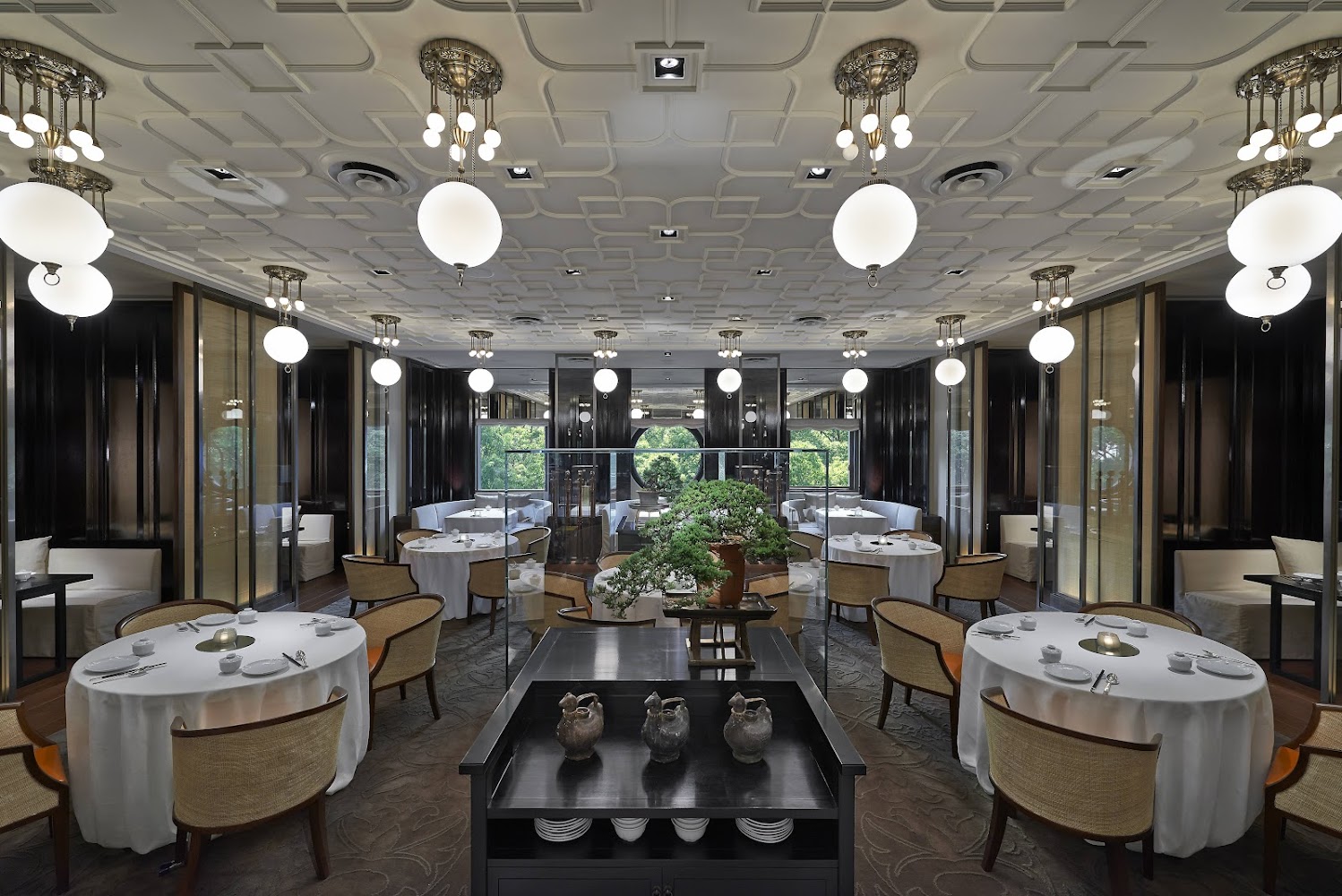 雅閣餐廳用餐空間,圓桌與藤椅搭配現代吊燈,氛圍典雅高級。