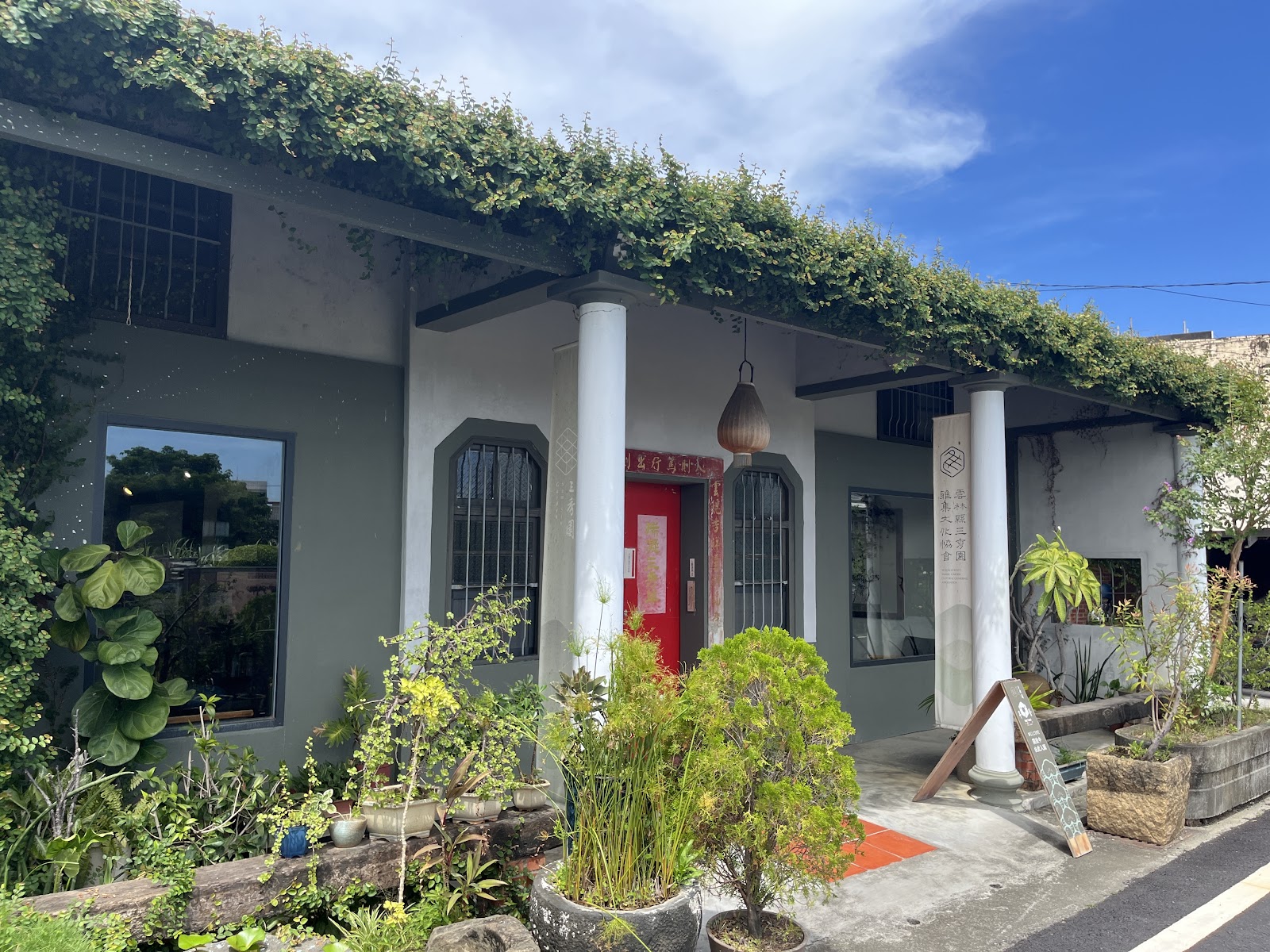 三秀園主建築外觀，白色牆面爬藤覆頂，朱紅色門，雲林大埤一日遊景點