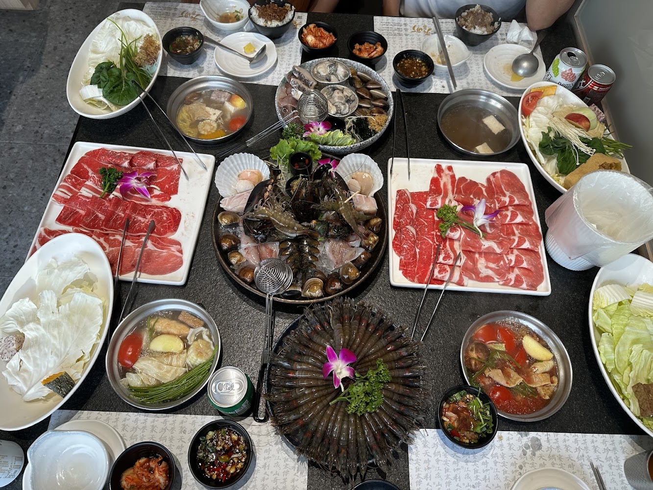 火鍋套餐有牛肉片海鮮拼盤蔬菜湯品與沾醬