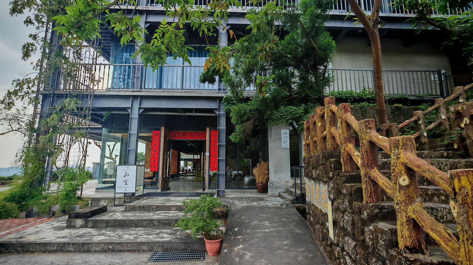 仙湖休閒農場山室建築入口,灰色鋼架搭配石階與紅色春聯