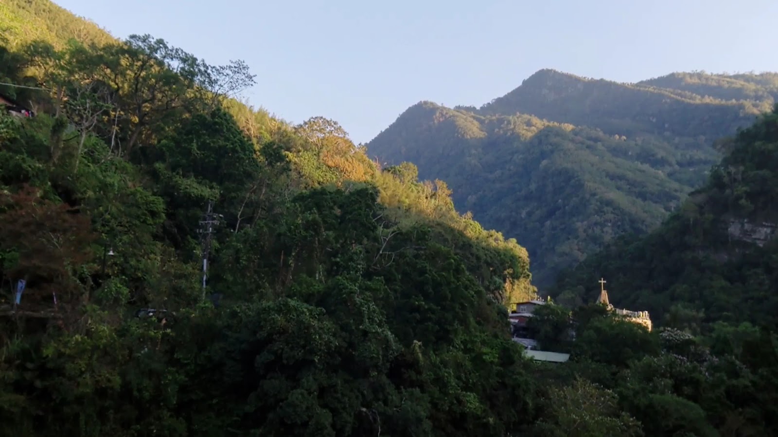 錦屏大橋周邊山谷夕陽餘暉與遠方教堂