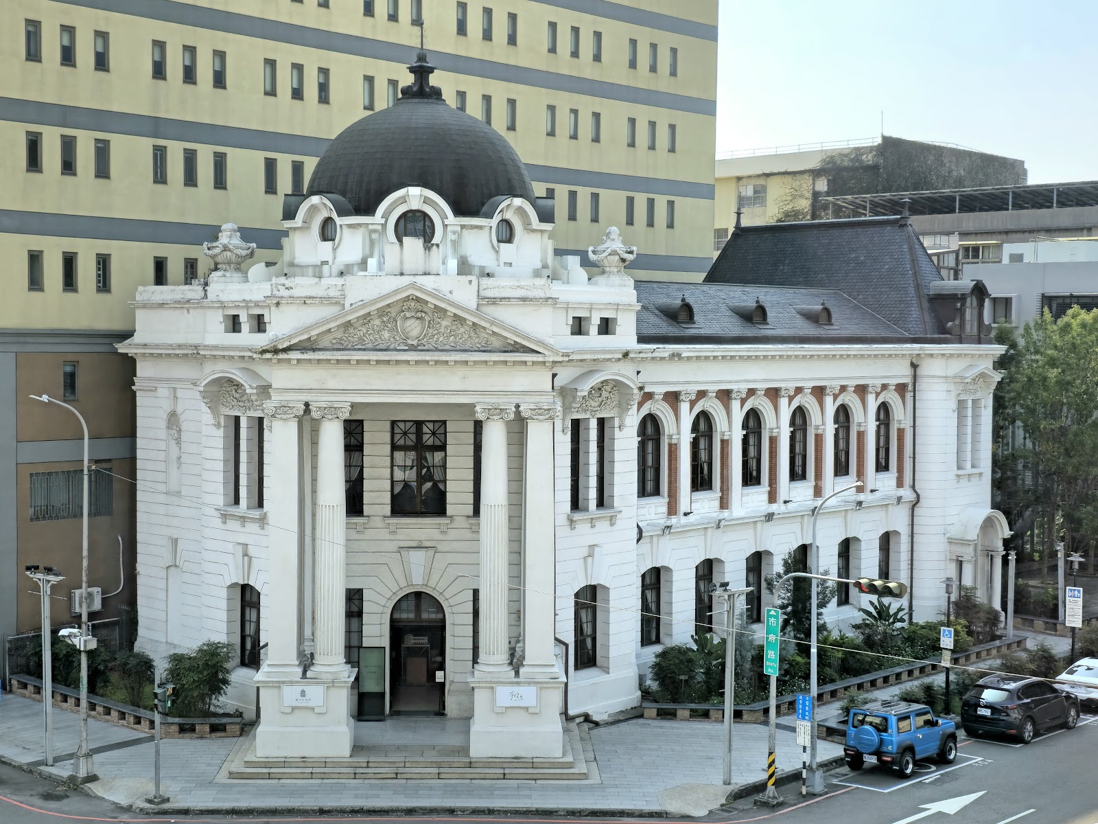 臺中市役所全景,白色新巴洛克建築外觀、黑色穹頂、磚紅拱廊,台中中區歷史景點