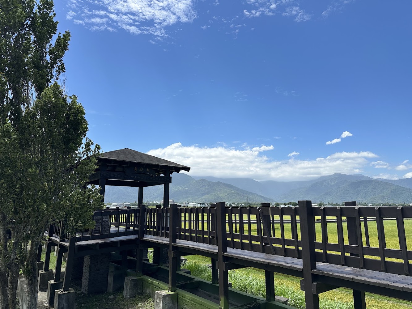 大觀亭周邊棧道、綠意田野與藍天下山景