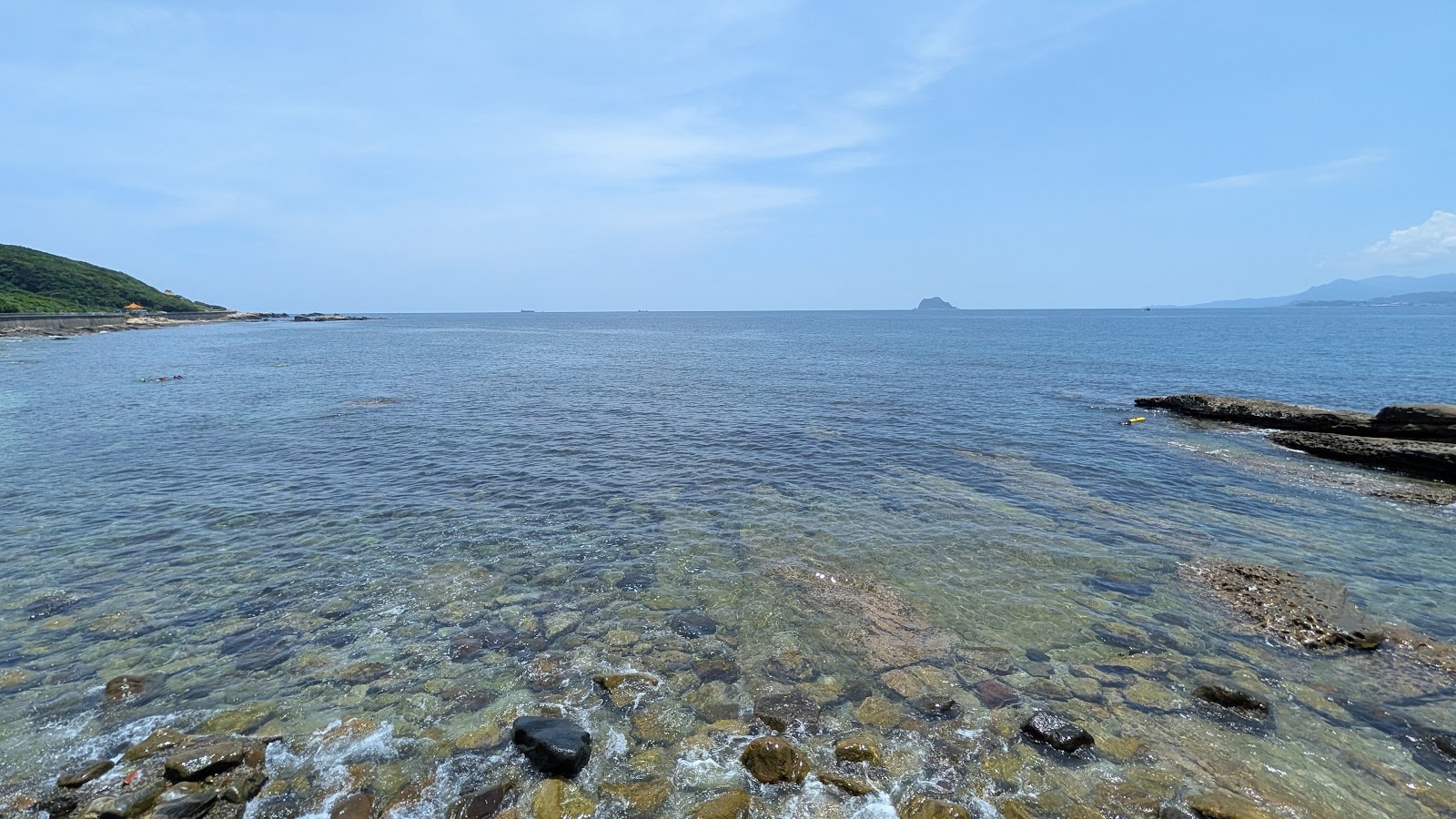龜吼螃蟹主題公園旁清澈礁石海岸,遠眺基隆嶼,晴天