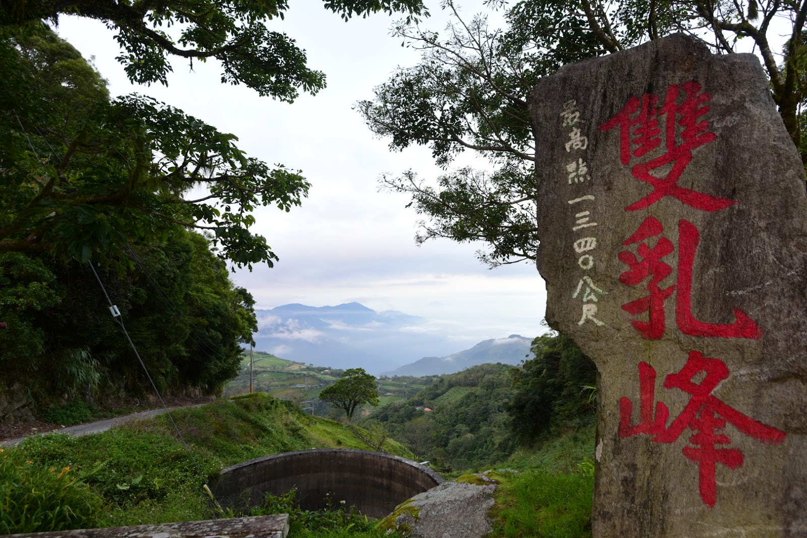 太麻里山雙乳峰石碑特寫,最高點2340公尺,背景雲霧繚繞山谷景色