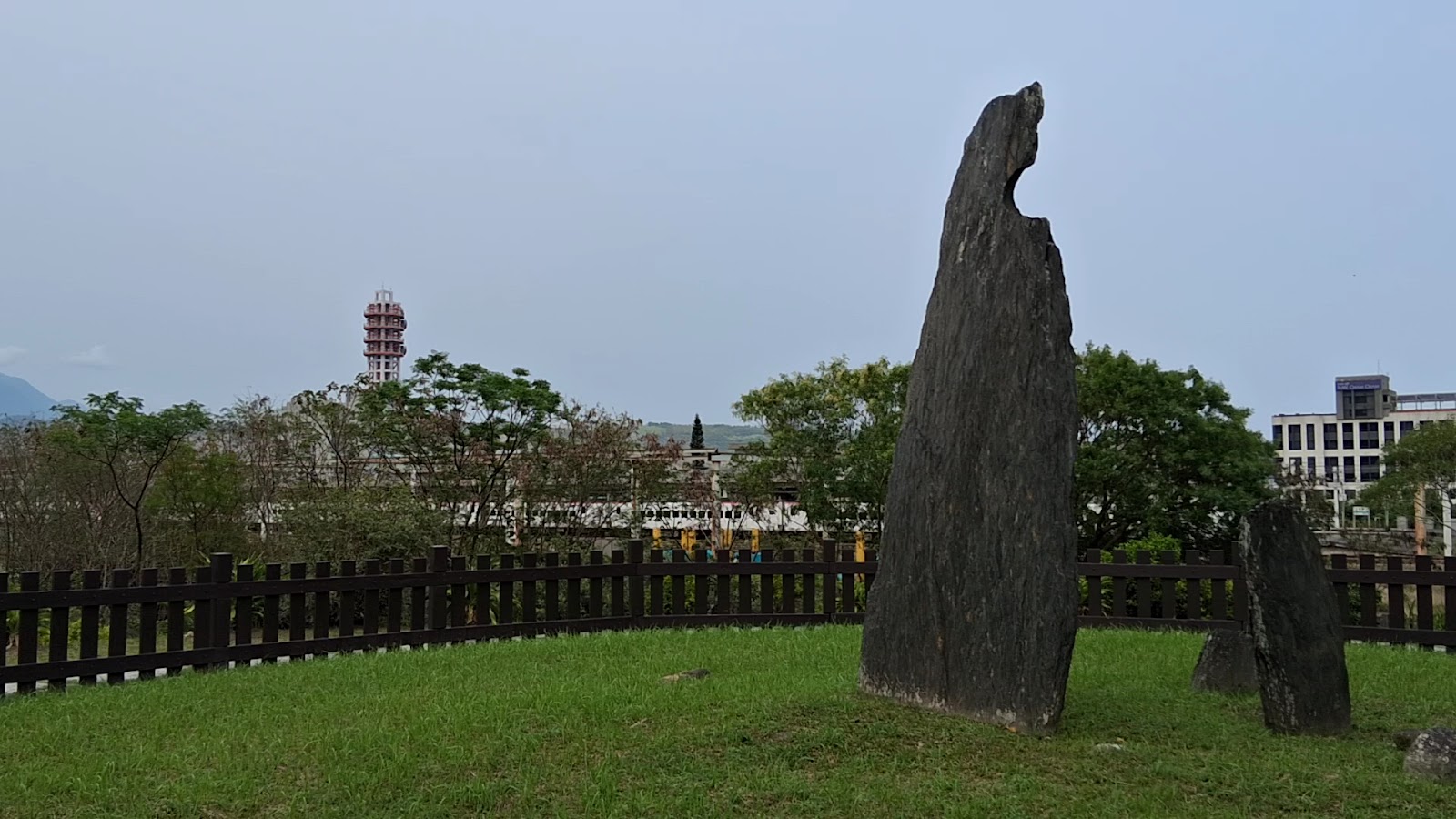 月形石柱與現代建築同框畫面