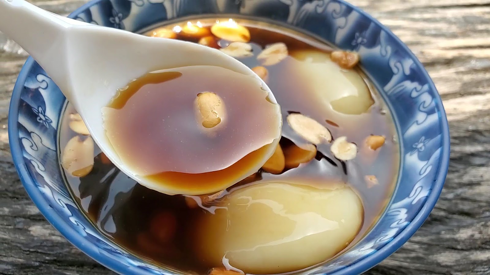 牛汶水湯匙舀起麻糬 黑糖薑汁湯滴落