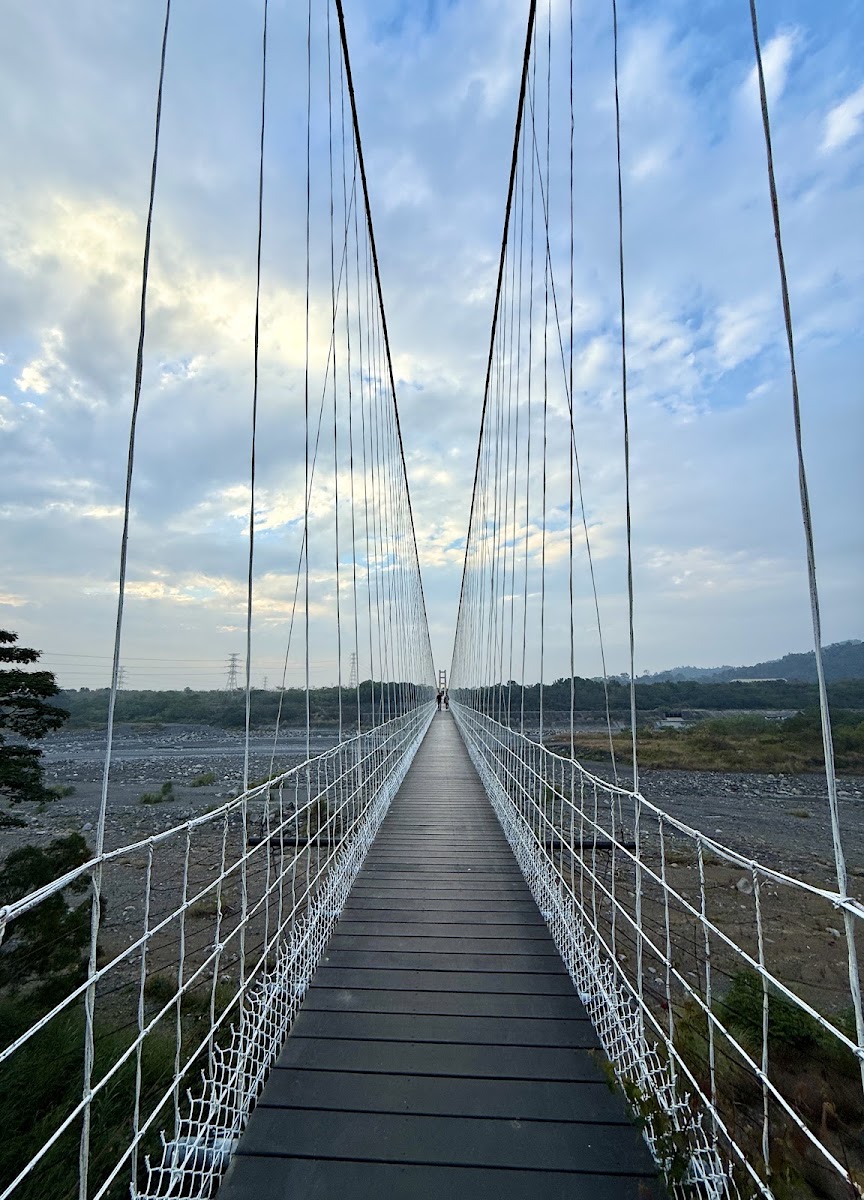 丹林吊橋橫跨山谷，木板橋面懸掛於翠綠山林之間