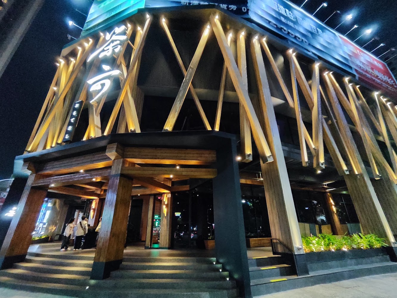 茶六燒肉堂博愛店夜間外觀木質建築